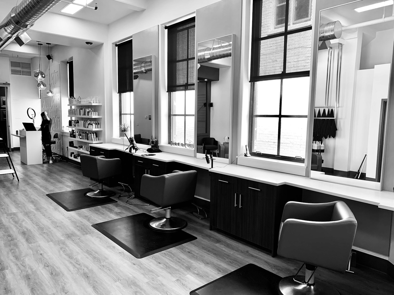 Minimal hair salon interior with styling chairs