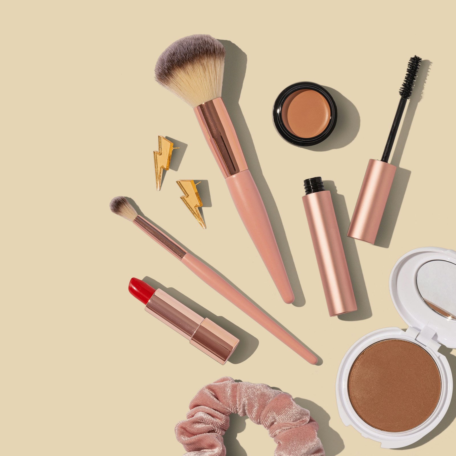 Skincare and makeup objects arranged on a warm surface
